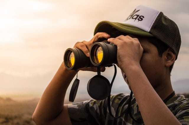 Man looking through binoculars 