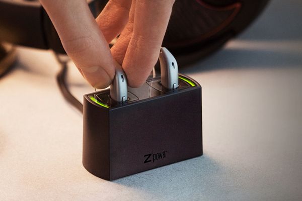 Placing rechargeable hearing aids in their charging cradle