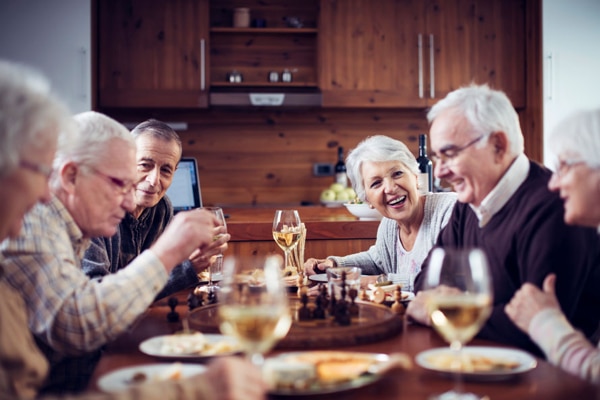 A group of elderly people enjoying dinner together