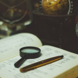 magnifying glass and an old book