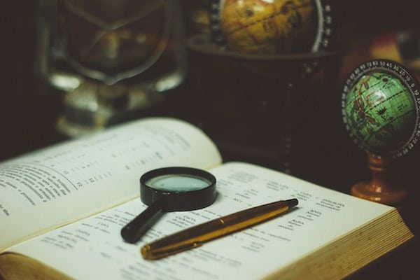 magnifying glass and an old book