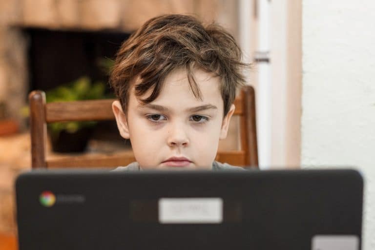 Young boy on a laptop doing school work