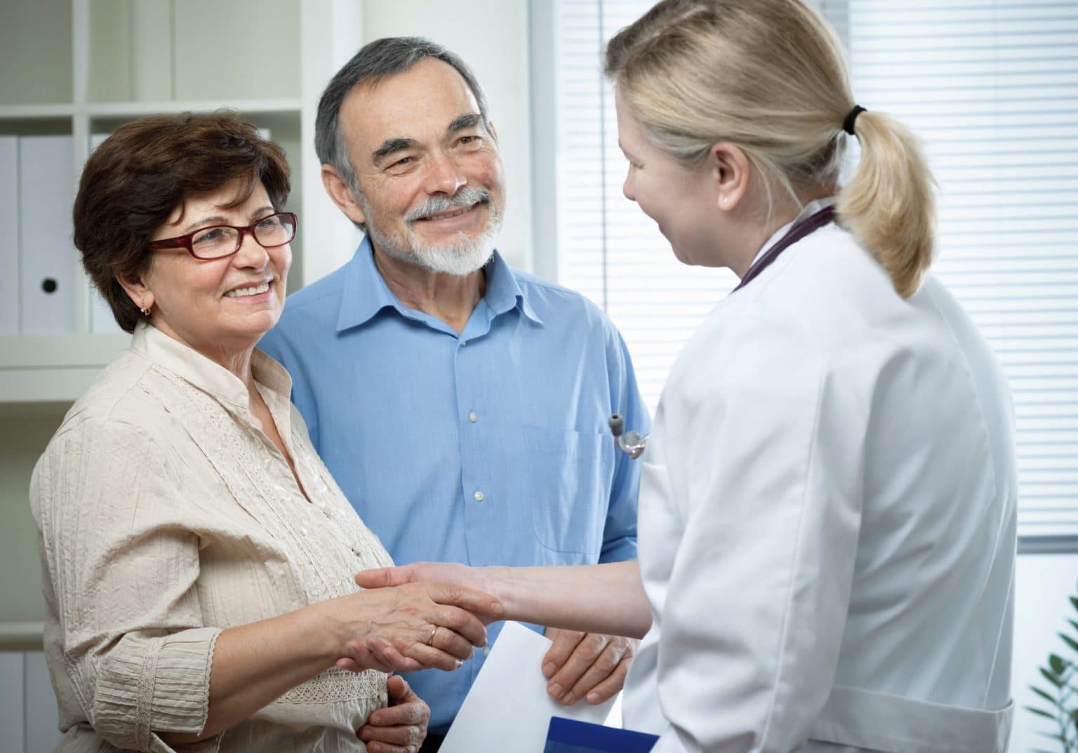 Couple Receiving Hearing Aid Counseling From a hearing care provider During a Fitting 