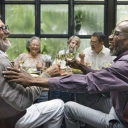 A group of friends laughing and talking at dinner.