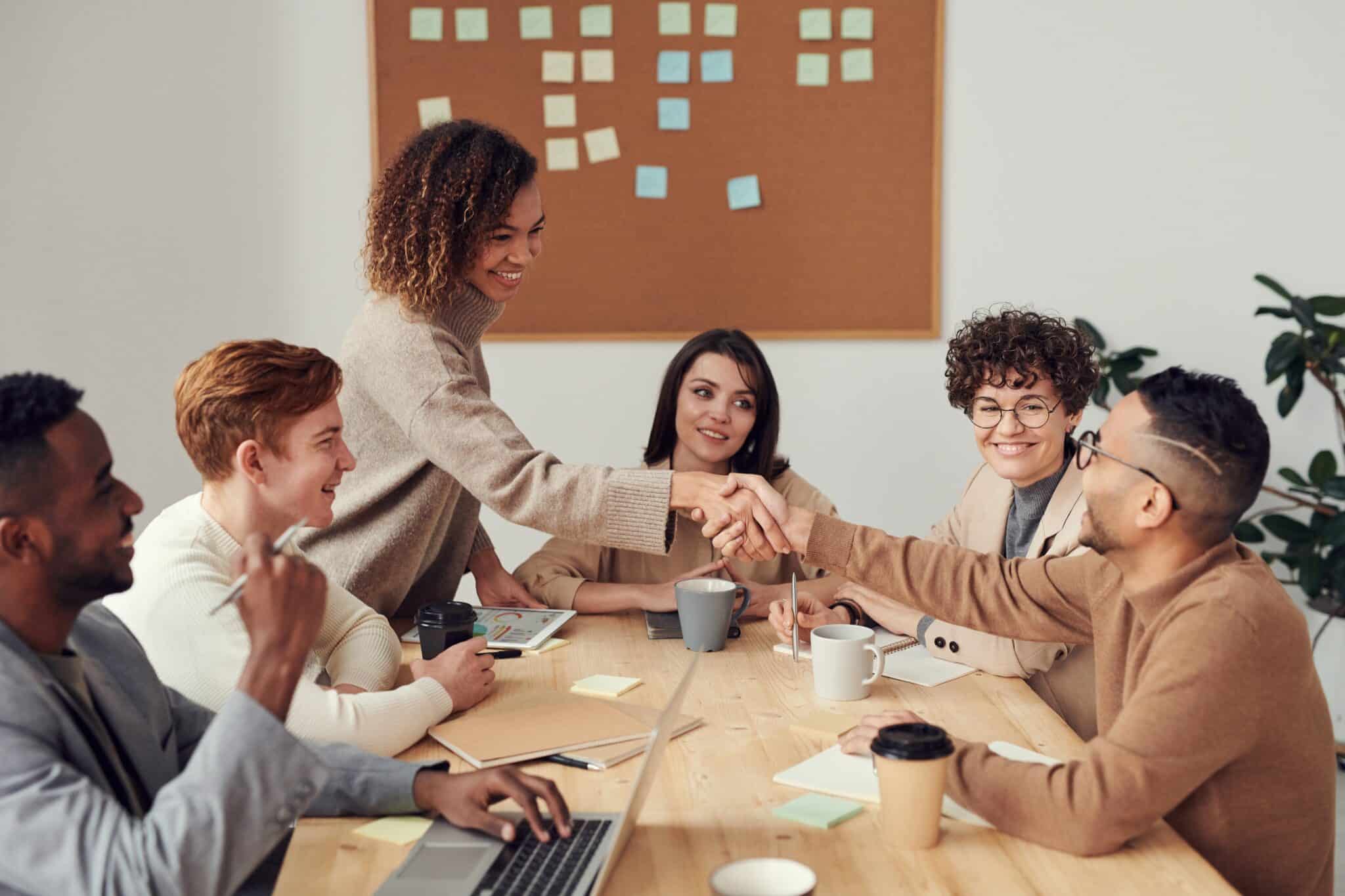 Coworkers shaking hands in a business meeting.