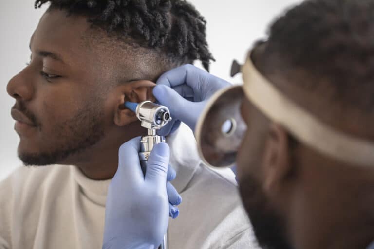 Man gets ear examined by doctor