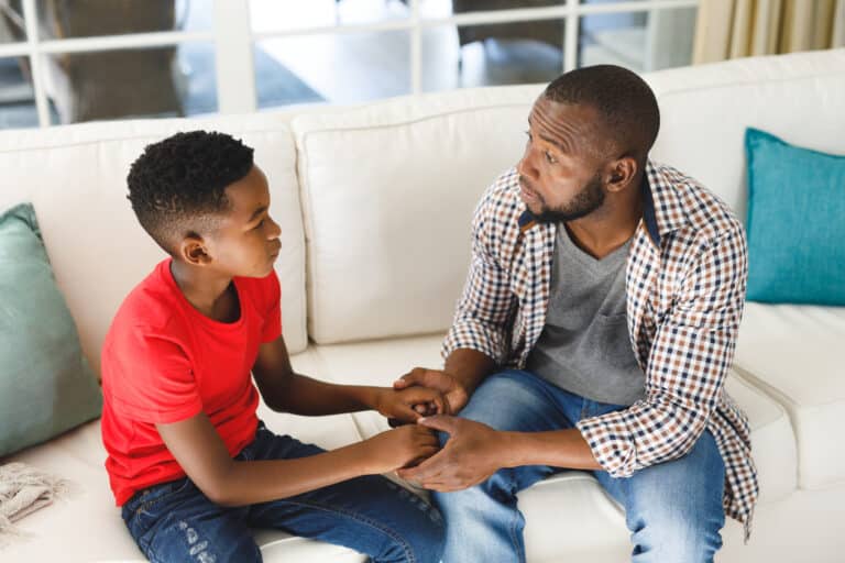 Father and son having a conversation on the couch