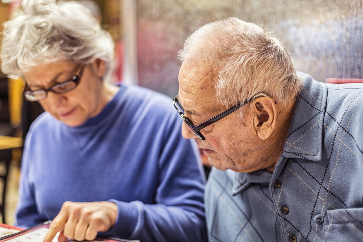 Man with hearing aids at restaurant