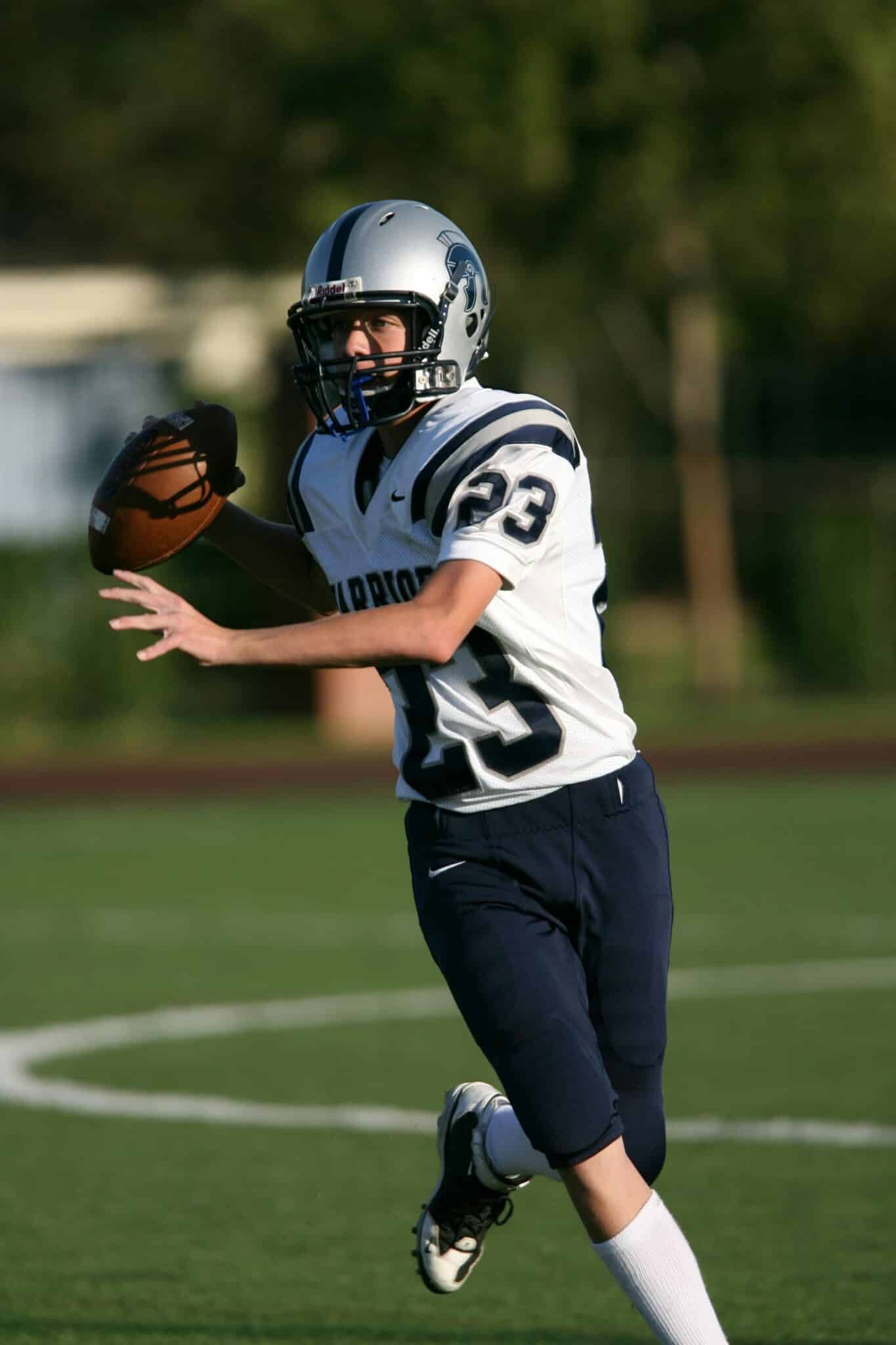 Football player on the field about to throw the ball.